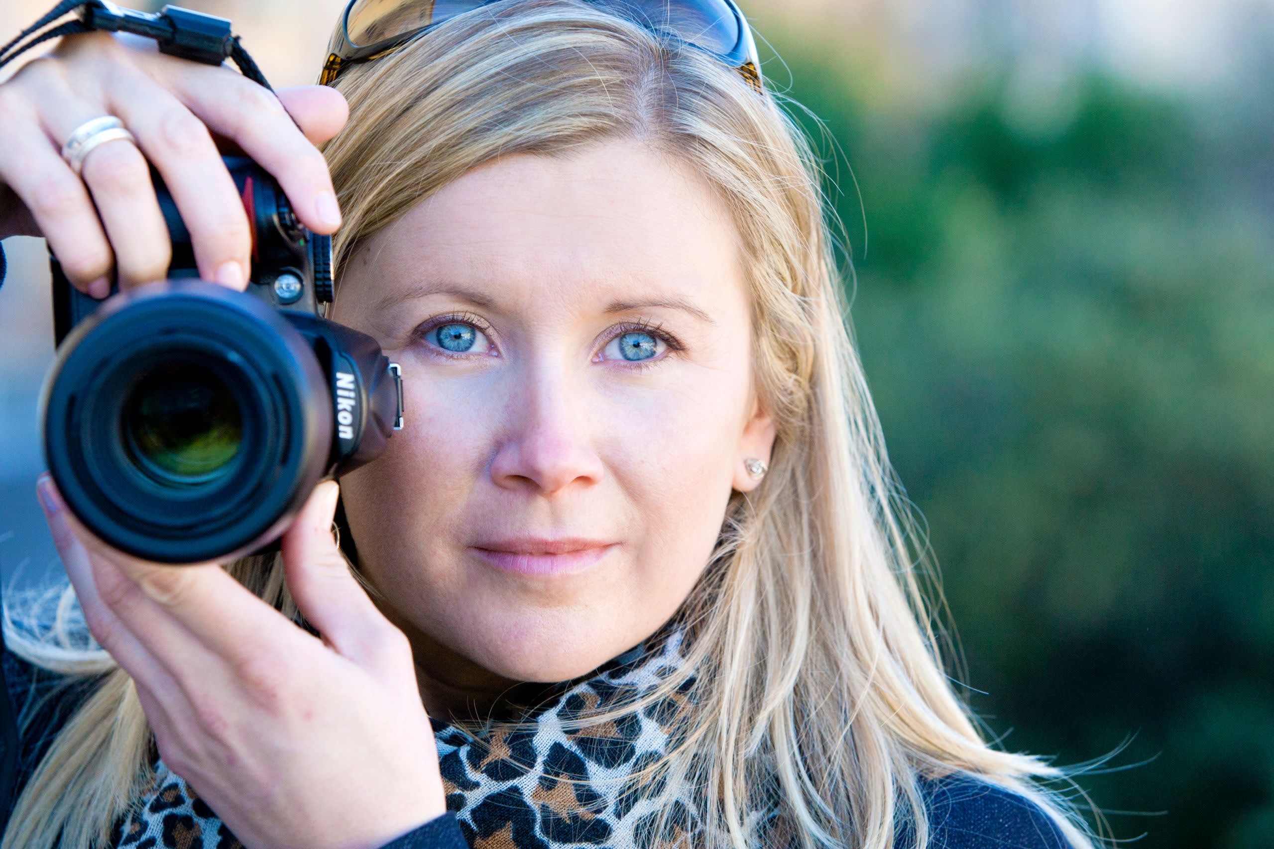 Close-up of Donna holding a Nikon camera